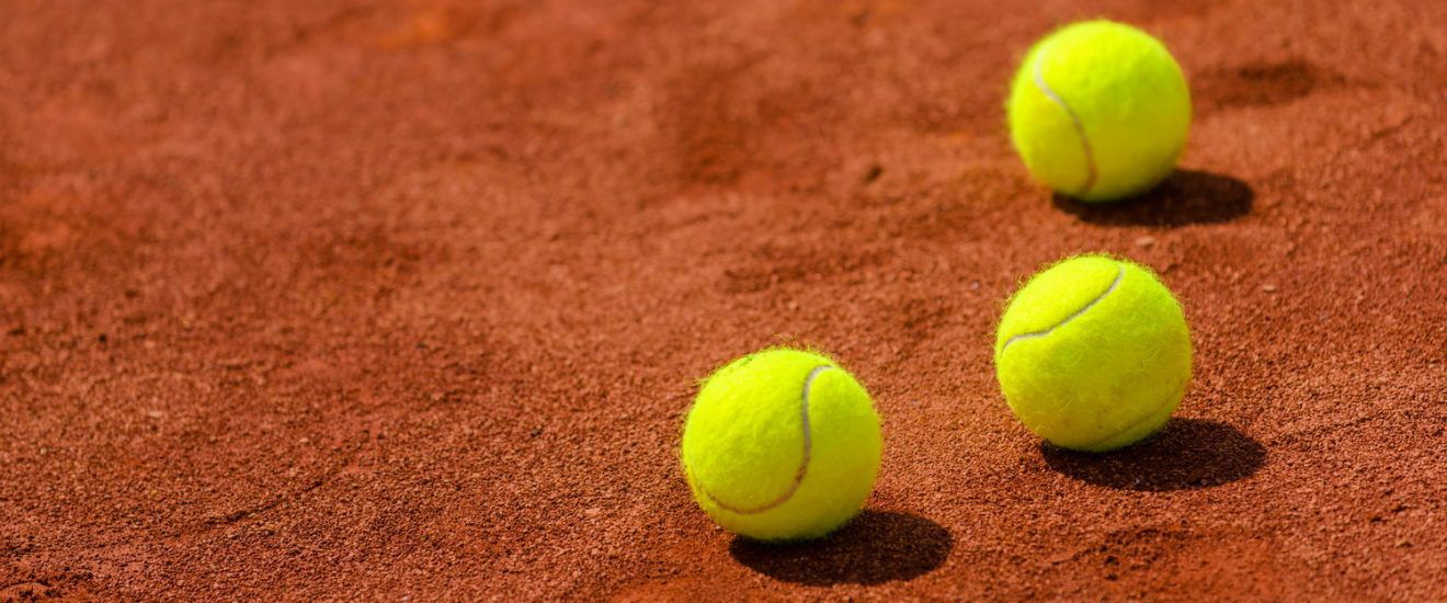 Tennis balls on clay court